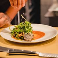 Person with Plate of Food on Table Salads Collections